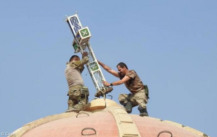 Soldaten richten das Kreuz auf einer Kirchenkuppel im irakischen Batnaya wieder auf (Herbst 2016).