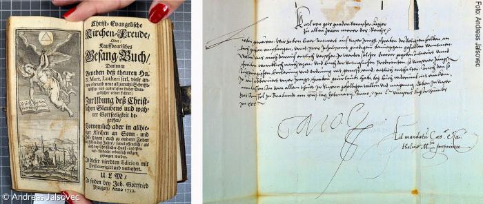 Links ein evangelisches Gesangbuch aus dem 18. Jahrhundert. Daneben ein Brief des katholischen Kaisers Karl V. an die Stadt Kaufbeuren aus dem Jahr 1535.