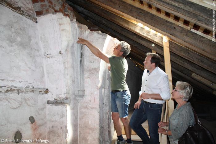 Bauleiter Zbigniew Winnicki (li.) und Architektin Ingrid Stetter zeigen Dekan Christoph Schieder bei einer Begehung Details der Sanierung der Kirche.