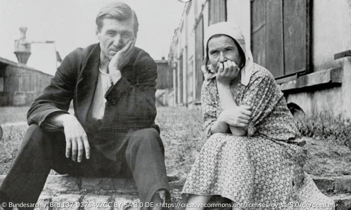 Schwarz-weiß Porträt eines Mannes und einer Frau, die nebeneinander sitzen.