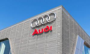 Das Audi-Logo (vier ineinander verschränkte Kreise) auf einem Gebäude.
