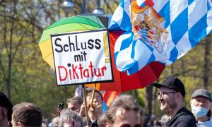 Demonstrant*innen mit einer bayerischen Fahne und einem Plakat "Schluss mit Diktatur"