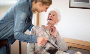 Eine junge Frau pflegt eine ältere Dame